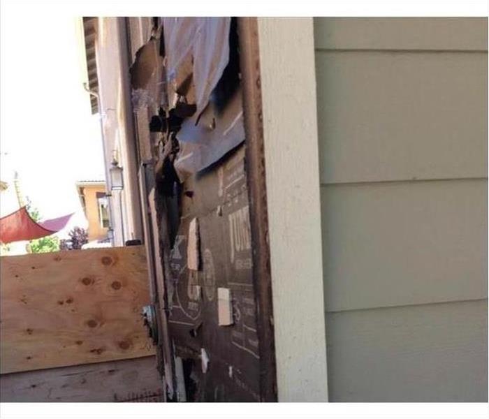 Electrical panel on the outside of a home with fire damage